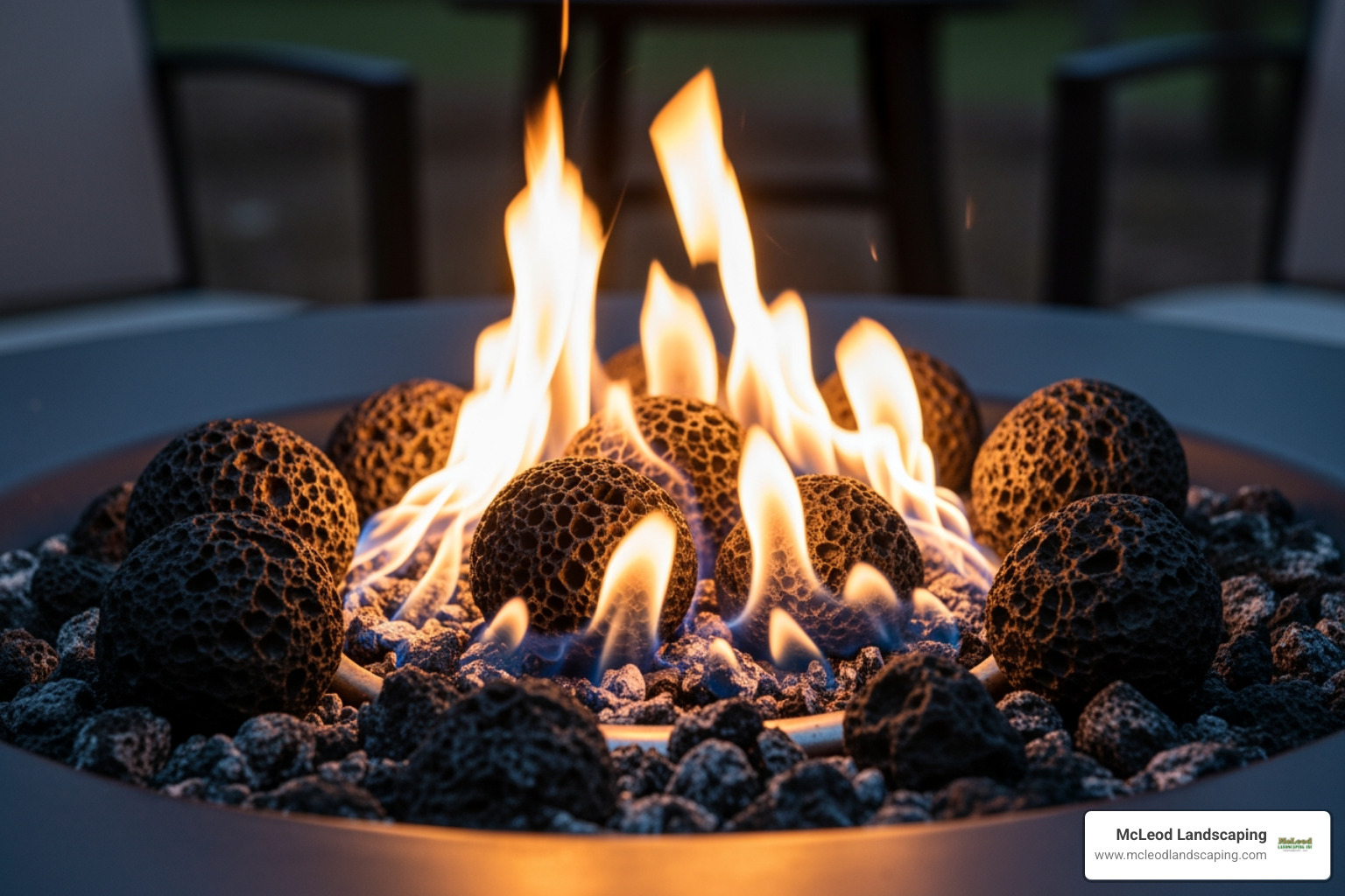 close-up on a gas fire pit's lava rocks and flames - outdoor table with firepit
